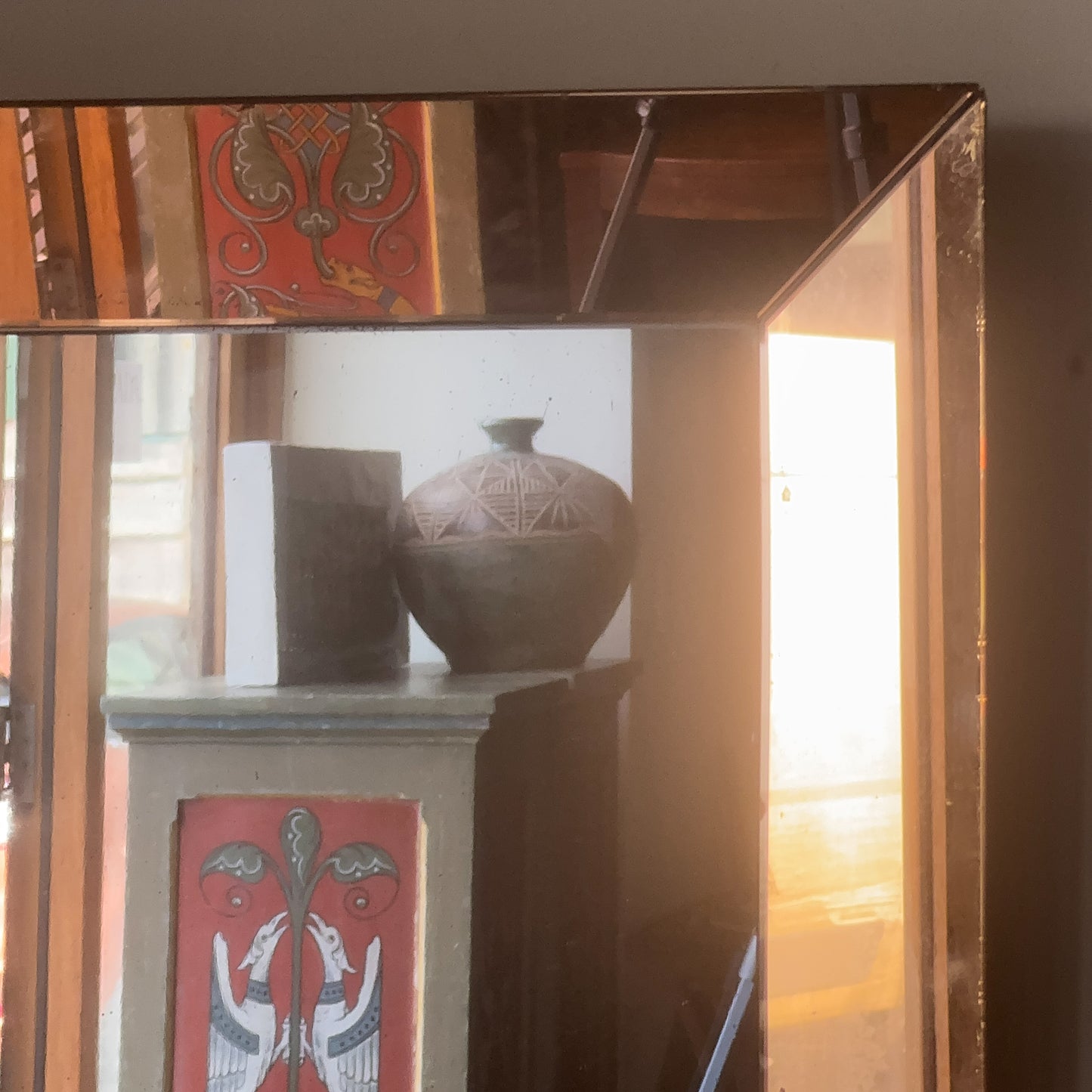 An Art Deco Peach Glass Mirror