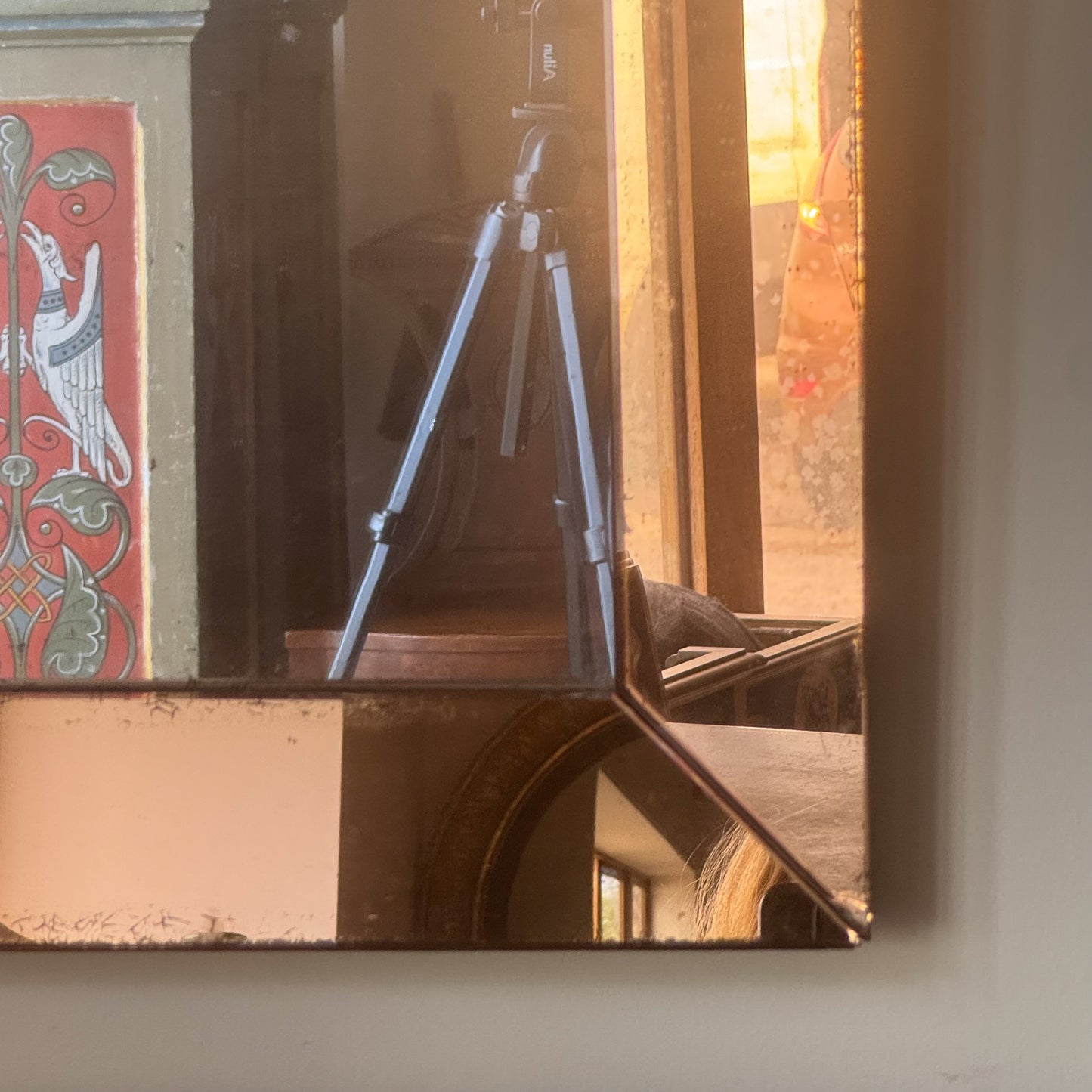 An Art Deco Peach Glass Mirror