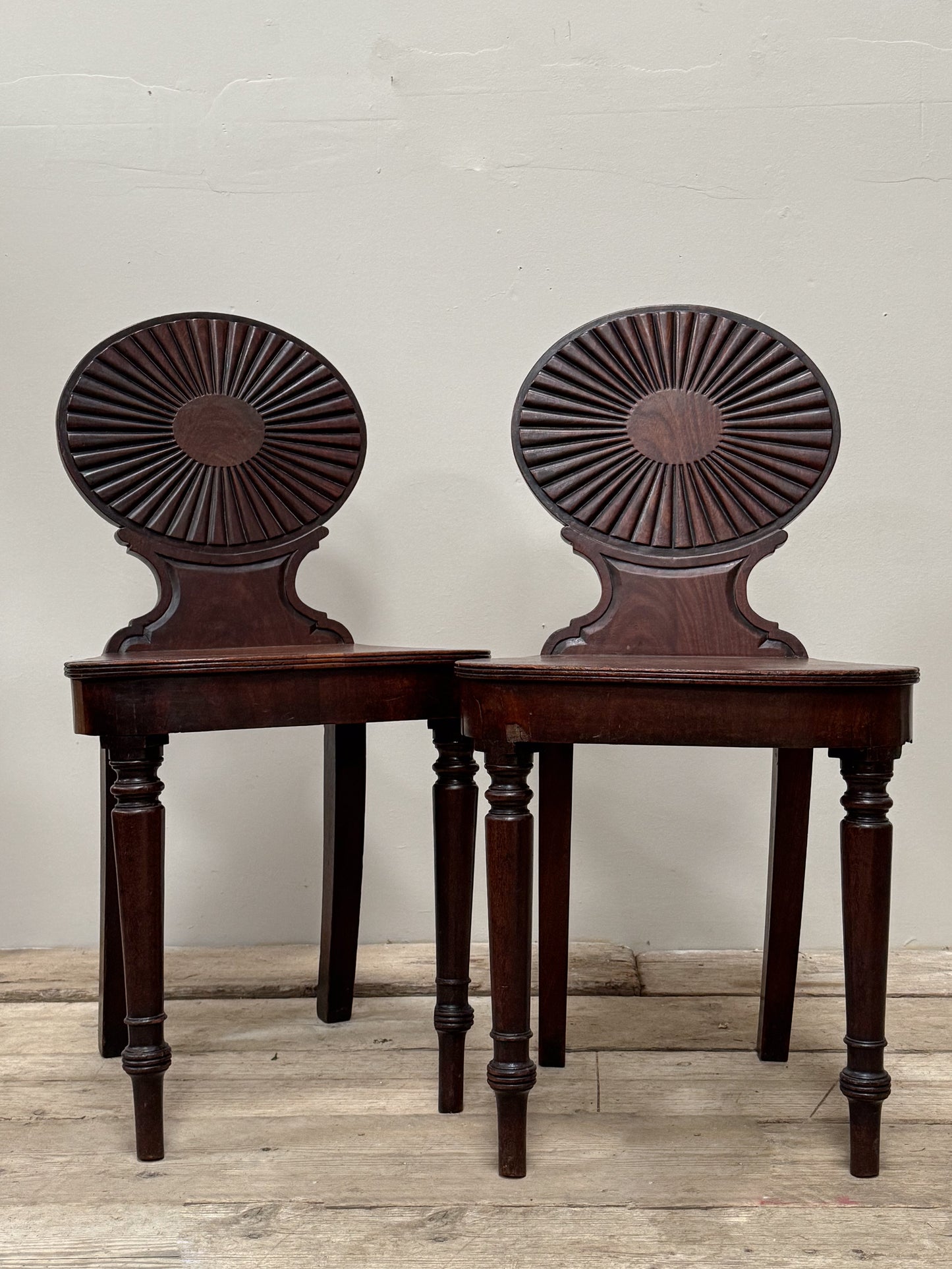 A Pair of George III Mahogany Hall Chairs