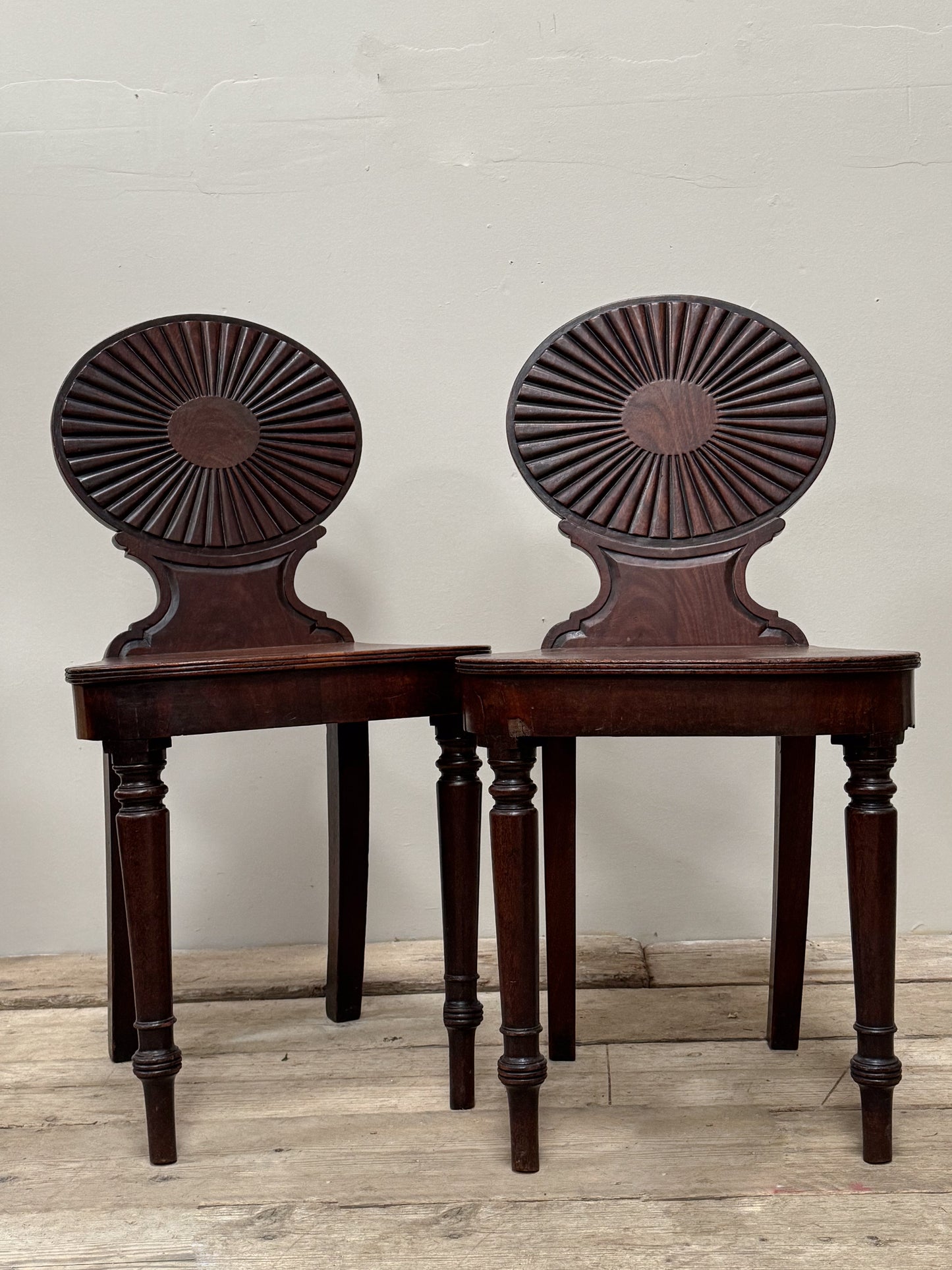 A Pair of George III Mahogany Hall Chairs