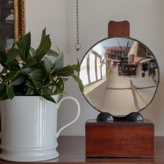 A Mid Century Parabolic Mirror on Regency Stand