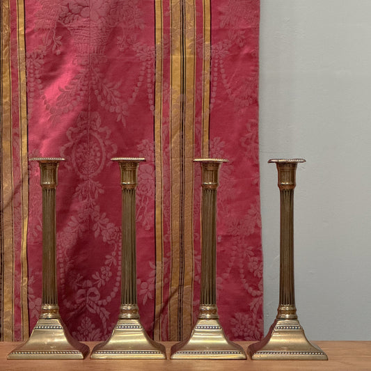 A Set of Four George III Brass Column Candlesticks