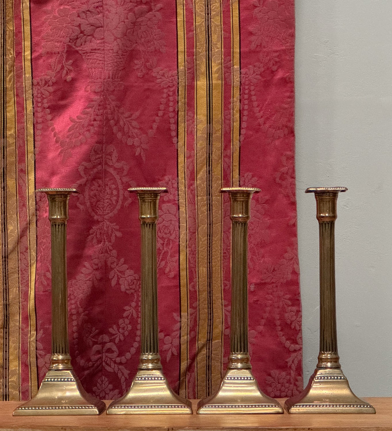 A Set of Four George III Brass Column Candlesticks