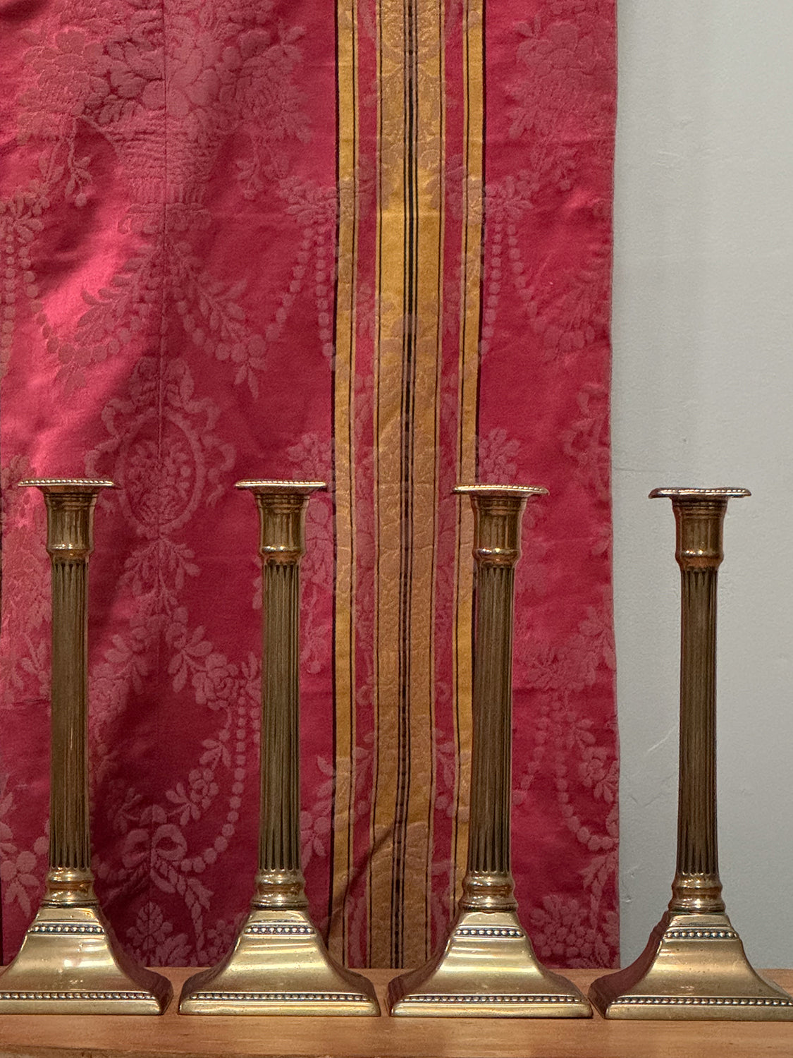 A Set of Four George III Brass Column Candlesticks