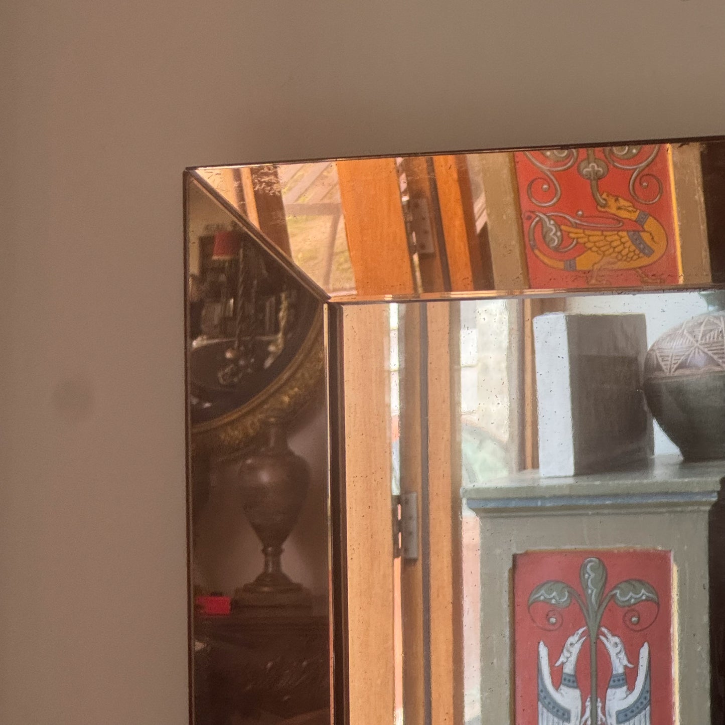 An Art Deco Peach Glass Mirror