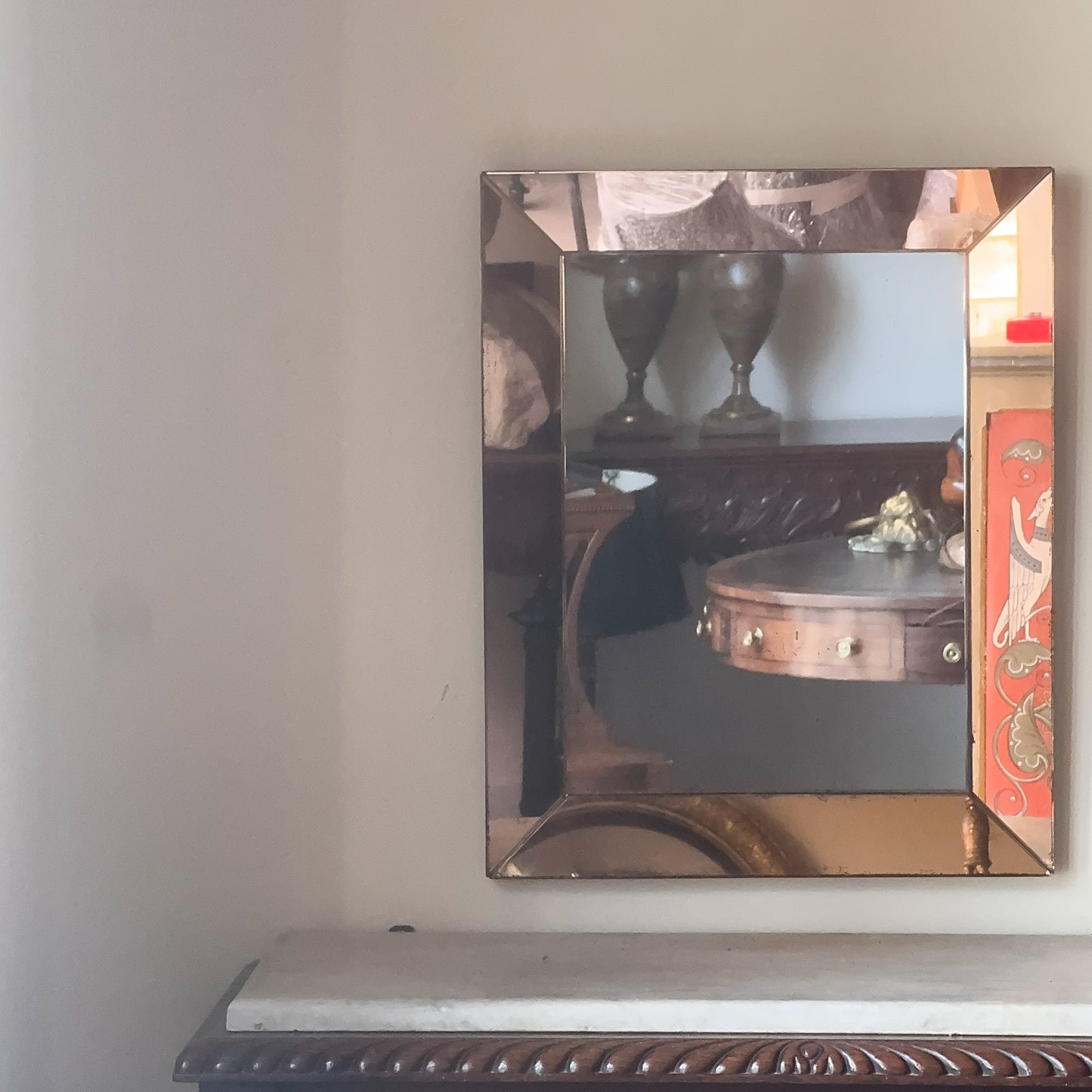 An Art Deco Peach Glass Mirror
