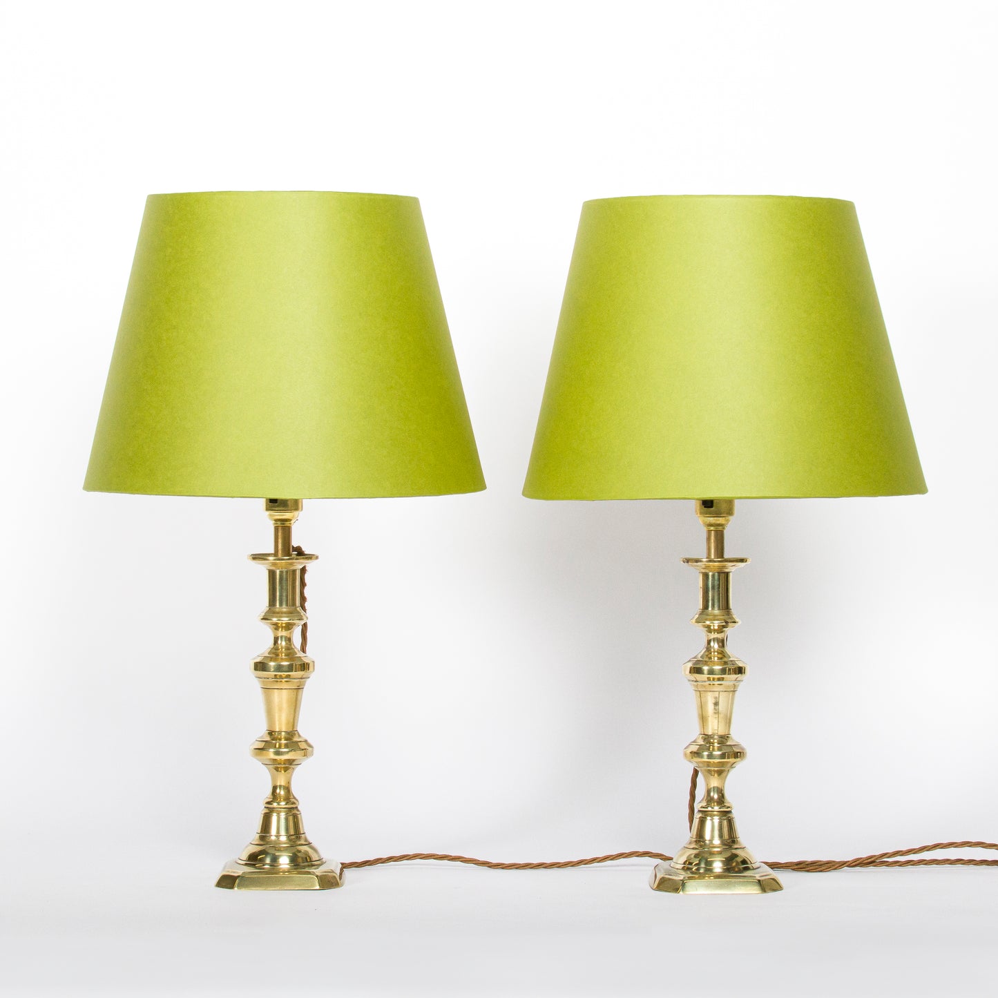 A pair of brass candlesticks converted to lamps, circa 1850